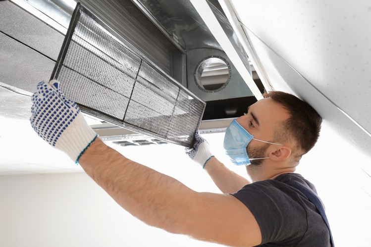 Service tech peforming air duct cleaning Santa Rosa CA, Sonoma County, Marin County